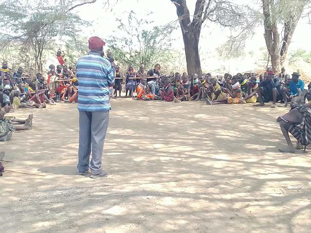 A community facilitator addresses the gathering